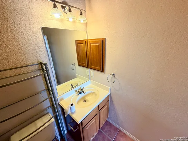 a bathroom with a sink and mirror