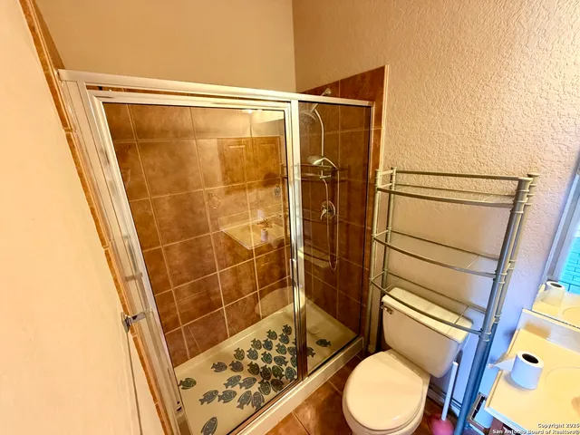 a bathroom with a toilet and a shower