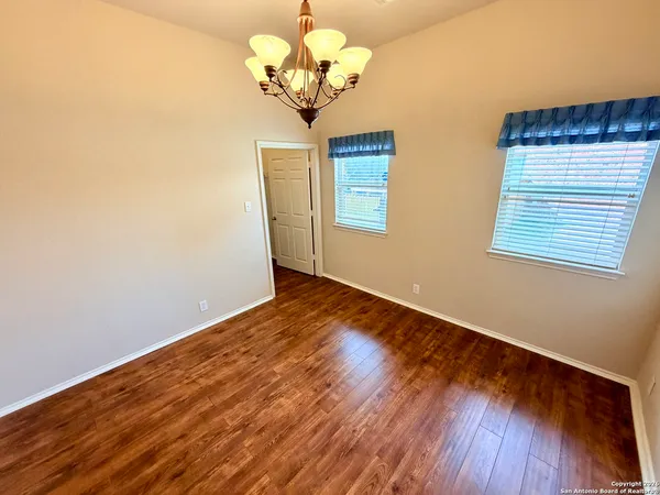 a view of a room with wooden floor and chandelier