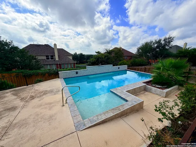 a view of a swimming pool with a lounge chairs