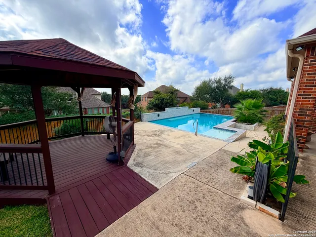 a view of a swimming pool with a patio