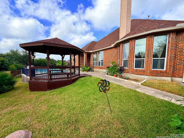 a house view with swimming pool and garden