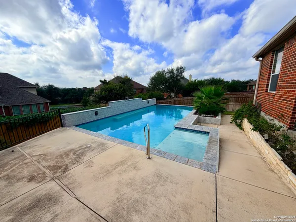 a view of swimming pool with a patio