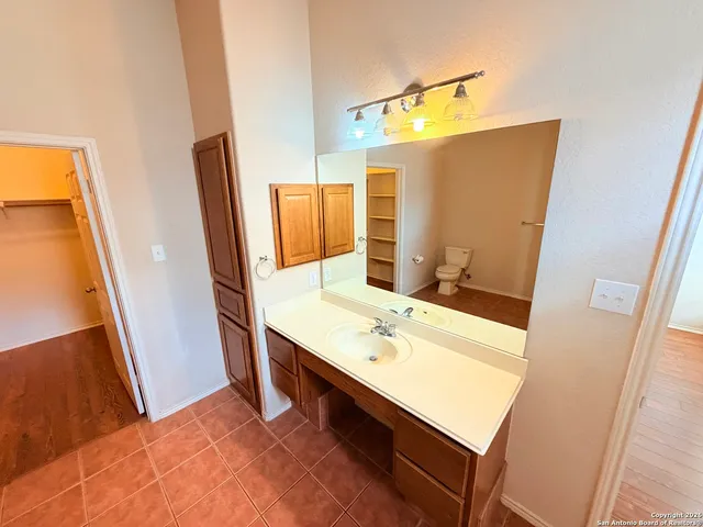 a bathroom with a sink vanity granite and a mirror