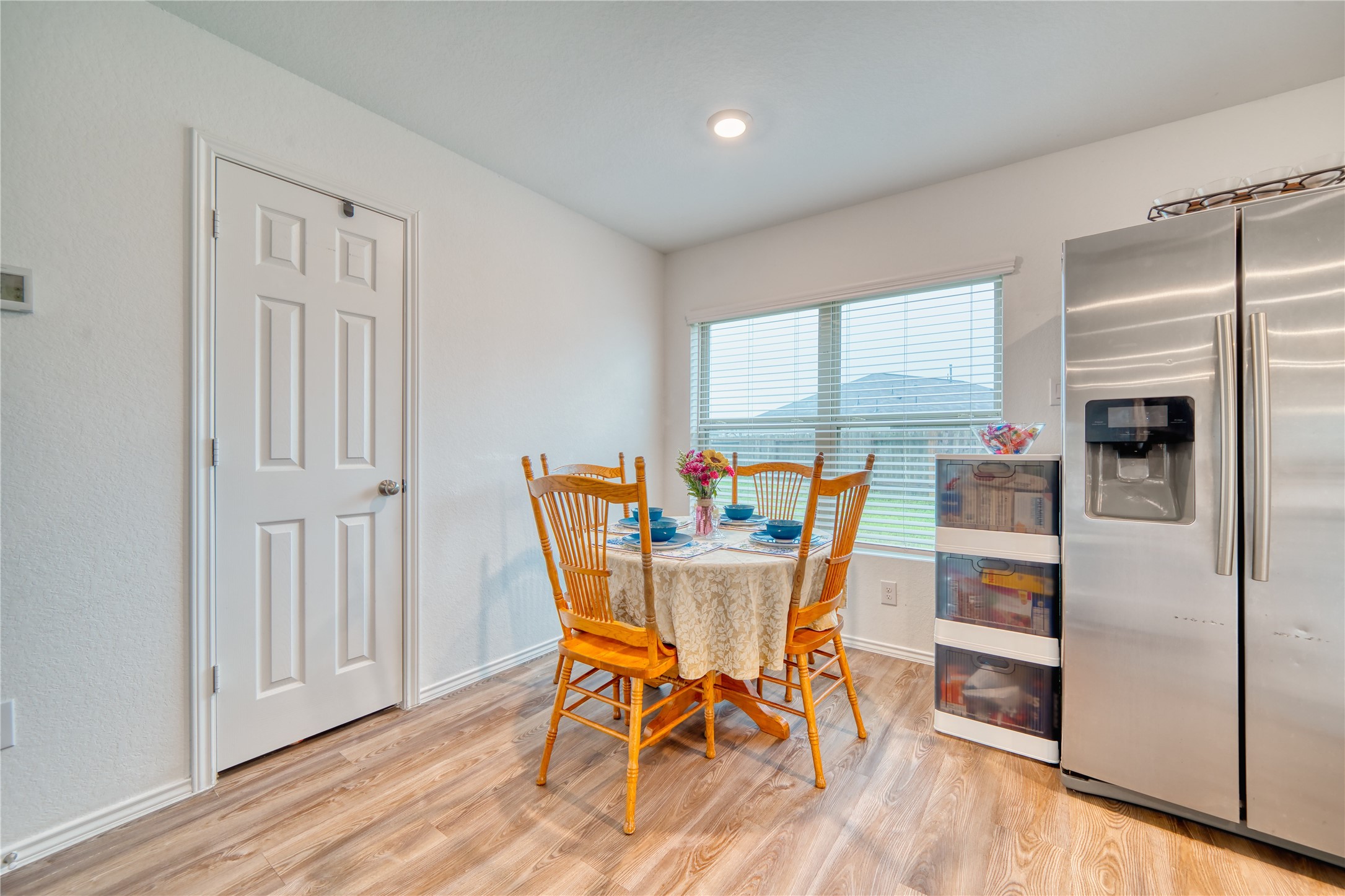 184 Kelly Street Angleton, TX 77515 - Photo 8 of 19 Light and airy breakfast area with beautiful wood-look floors, stainless appliances, and plenty of natural light. The perfect spot for morning coffee or casual family meals.