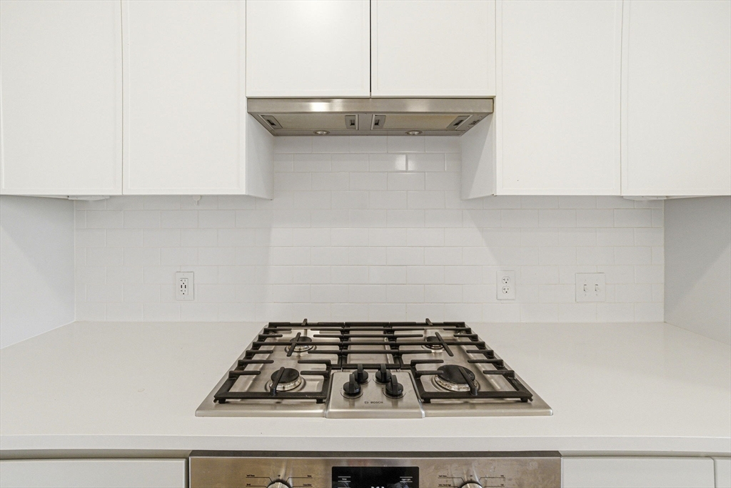 191 Washington Street, Unit 413 Boston, MA 02135 - Photo 14 of 40 a white stove top oven sitting inside of a kitchen