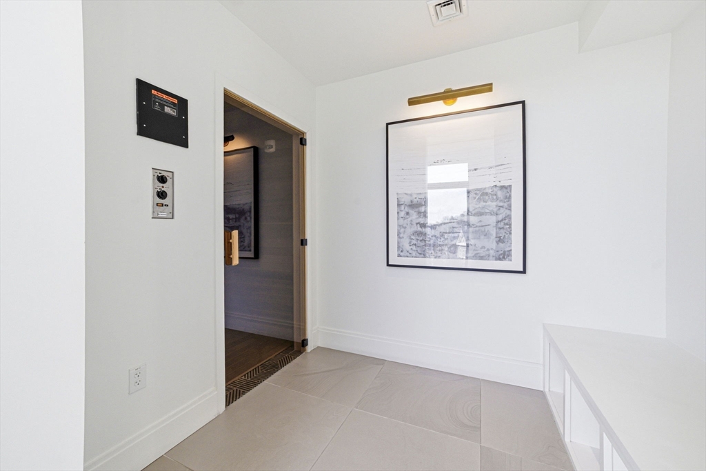 191 Washington Street, Unit 413 Boston, MA 02135 - Photo 39 of 40 a view of a hallway with front door