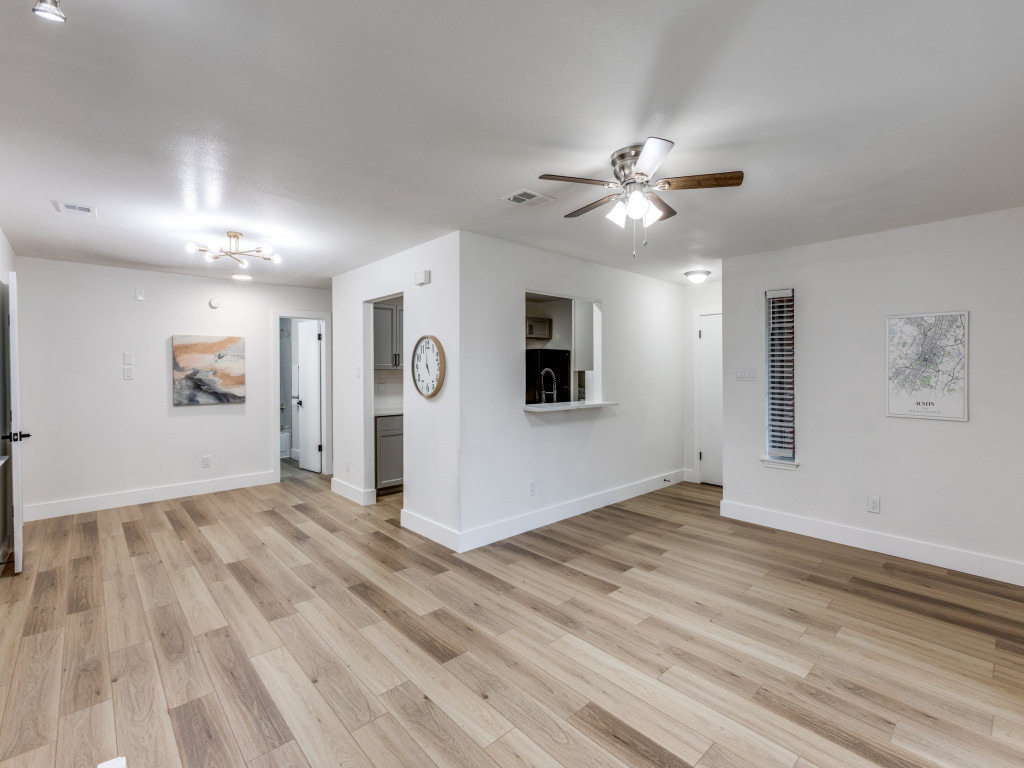 1845 River Crossing Circle, Unit A Austin, TX 78741 - Photo 12 of 31 Spare room featuring light wood-type flooring and a ceiling fan