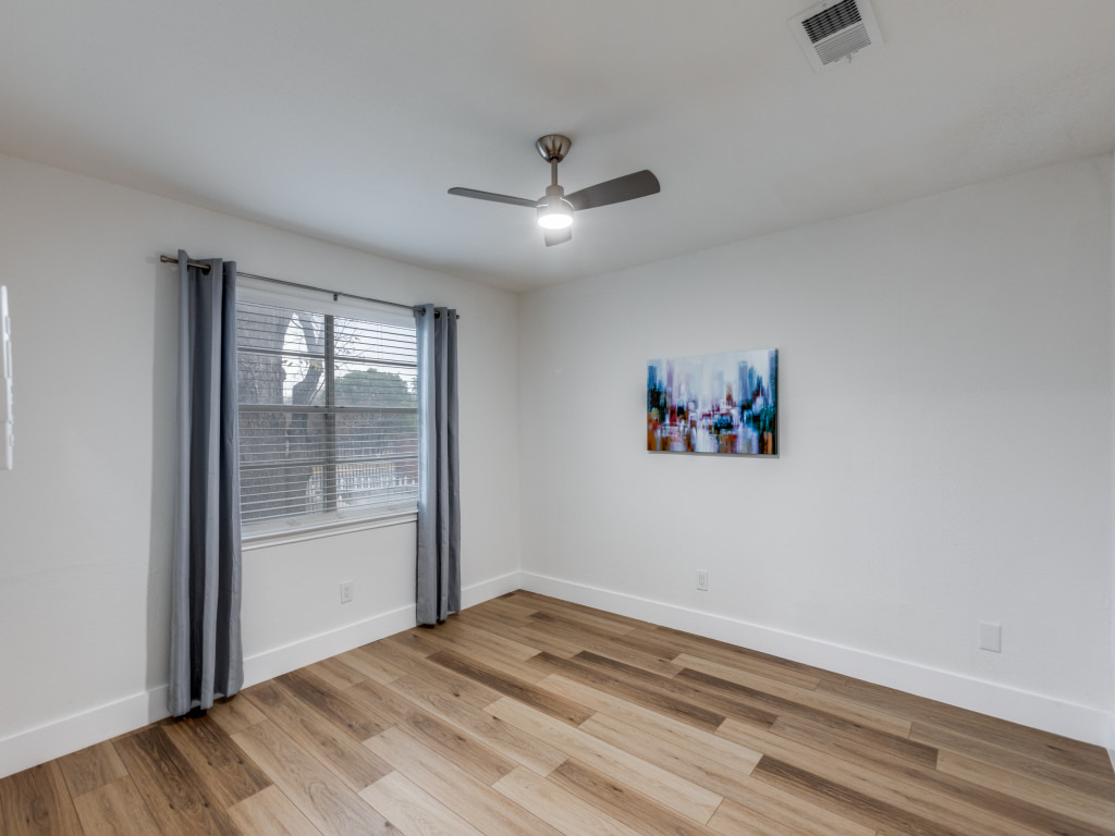 1845 River Crossing Circle, Unit A Austin, TX 78741 - Photo 18 of 31 Unfurnished room featuring light wood-type flooring and a ceiling fan