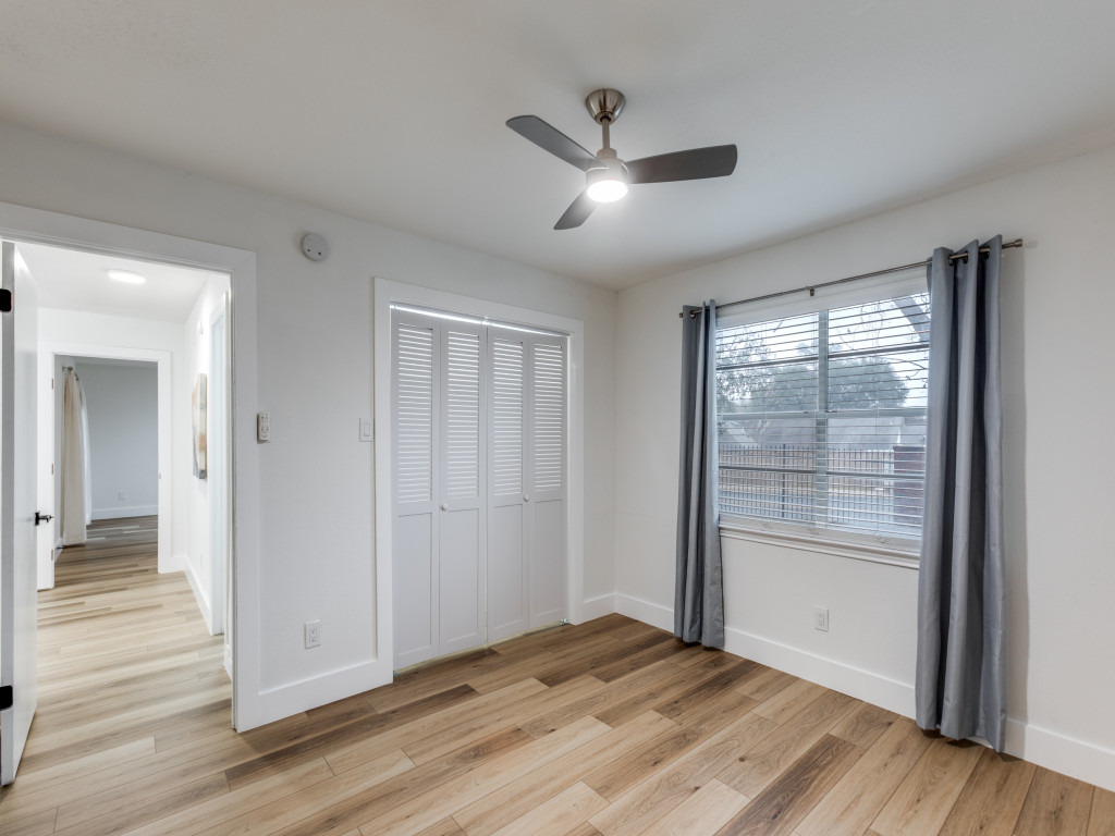 1845 River Crossing Circle, Unit A Austin, TX 78741 - Photo 19 of 31 Unfurnished bedroom with light wood-style flooring, a ceiling fan, and a closet