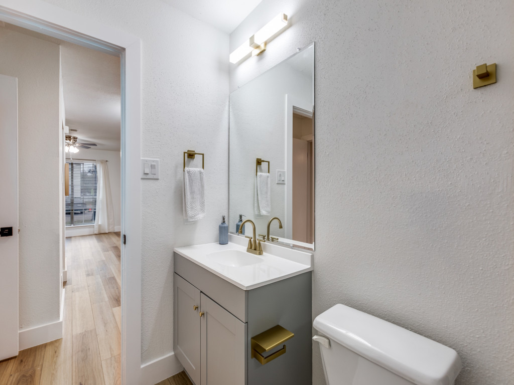 1845 River Crossing Circle, Unit A Austin, TX 78741 - Photo 20 of 31 Bathroom featuring vanity, ceiling fan, light wood-type flooring, and a textured wall
