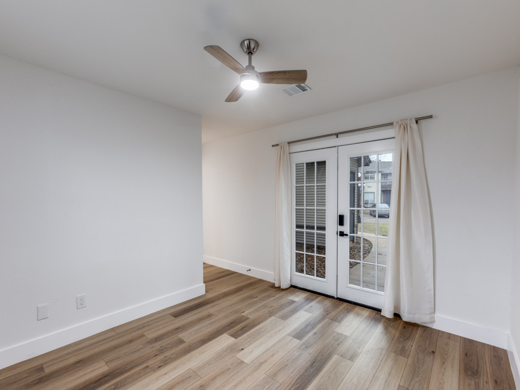 1845 River Crossing Circle, Unit A Austin, TX 78741 - Photo 22 of 31 Empty room featuring light wood-style flooring, french doors, and ceiling fan