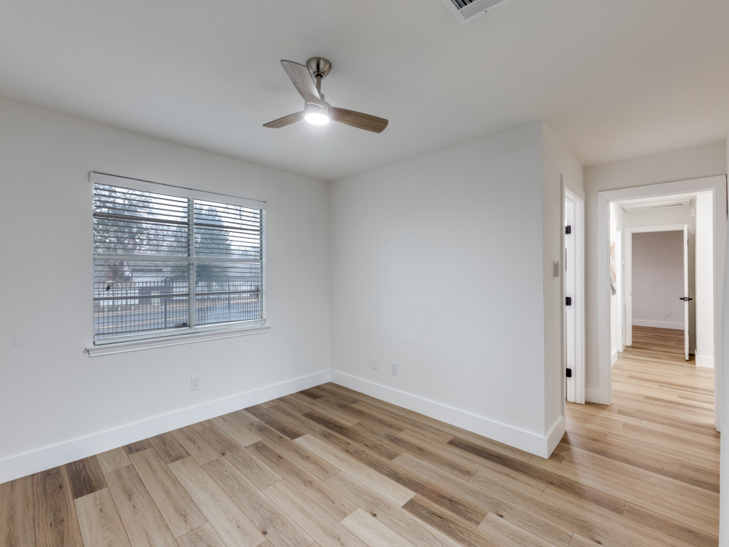 1845 River Crossing Circle, Unit A Austin, TX 78741 - Photo 23 of 31 Unfurnished room with light wood-style flooring and ceiling fan