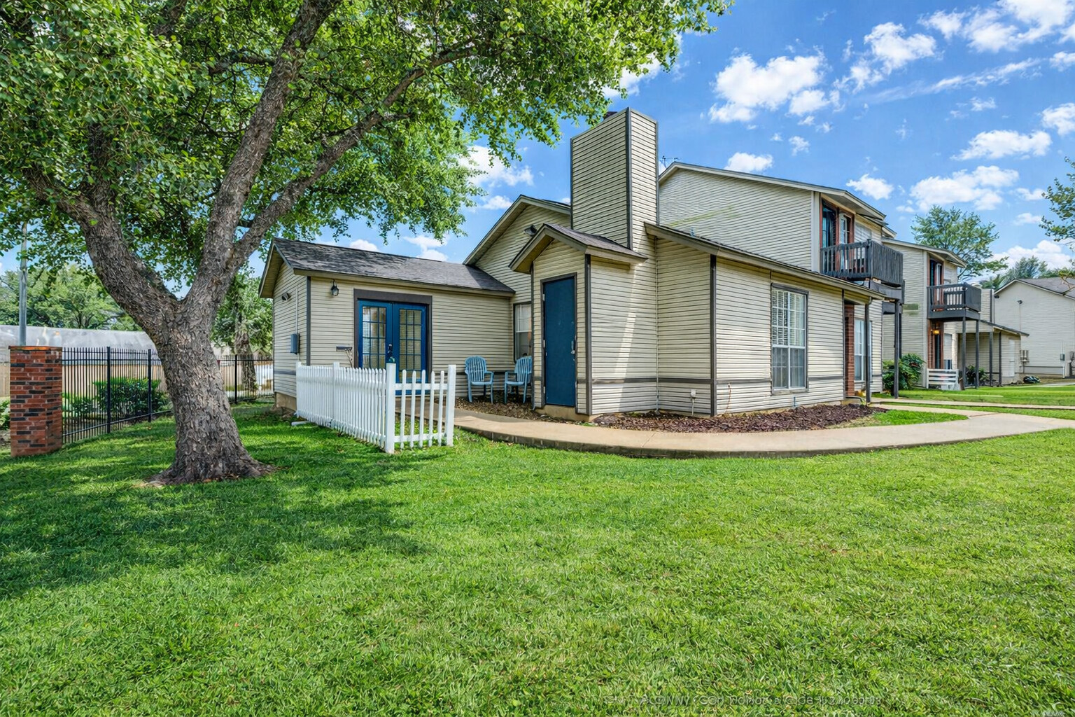 1845 River Crossing Circle, Unit A Austin, TX 78741 - Photo 7 of 31 Back of property featuring a chimney and french doors