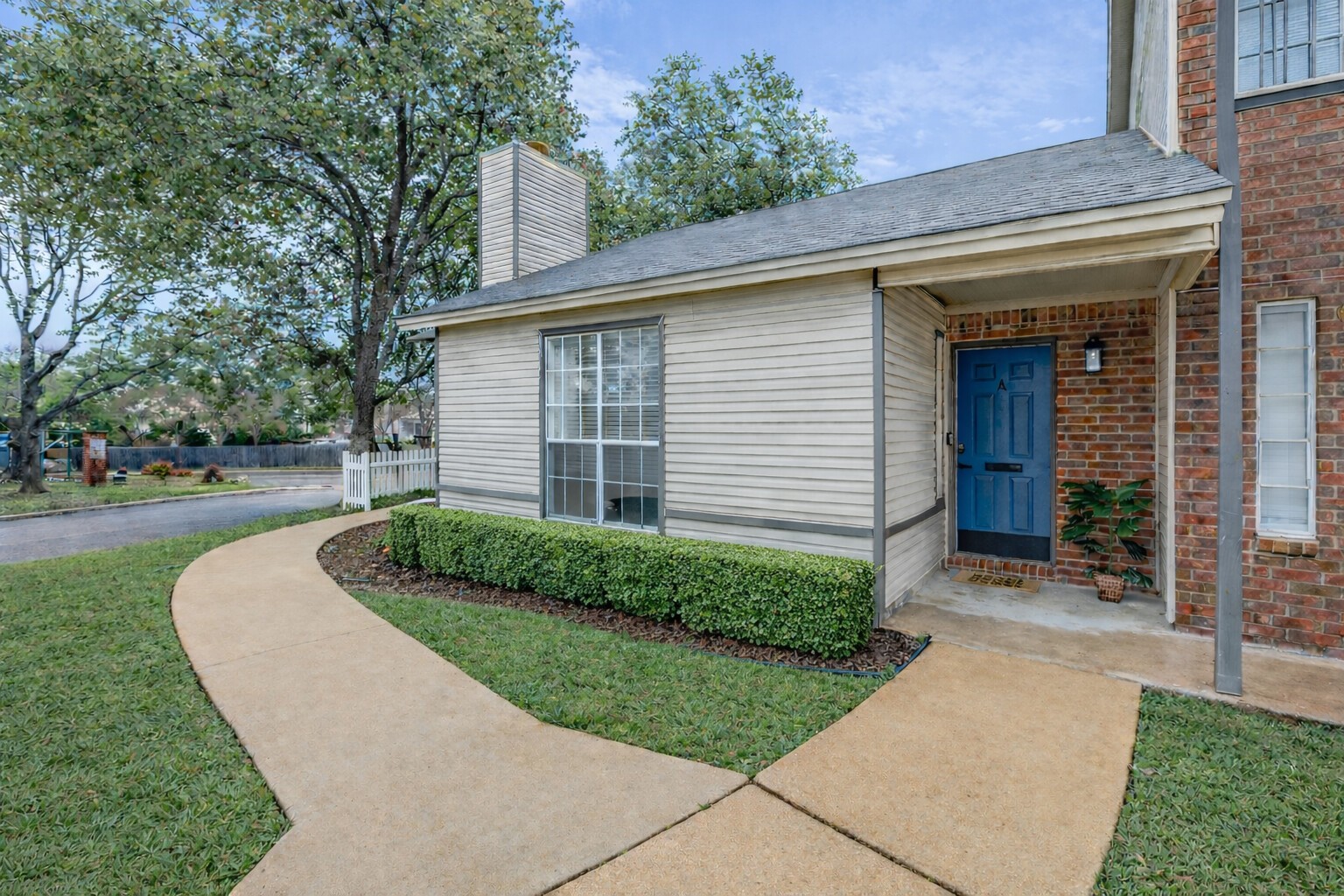 1845 River Crossing Circle, Unit A Austin, TX 78741 - Photo 8 of 31 View of exterior entry featuring a chimney and brick siding