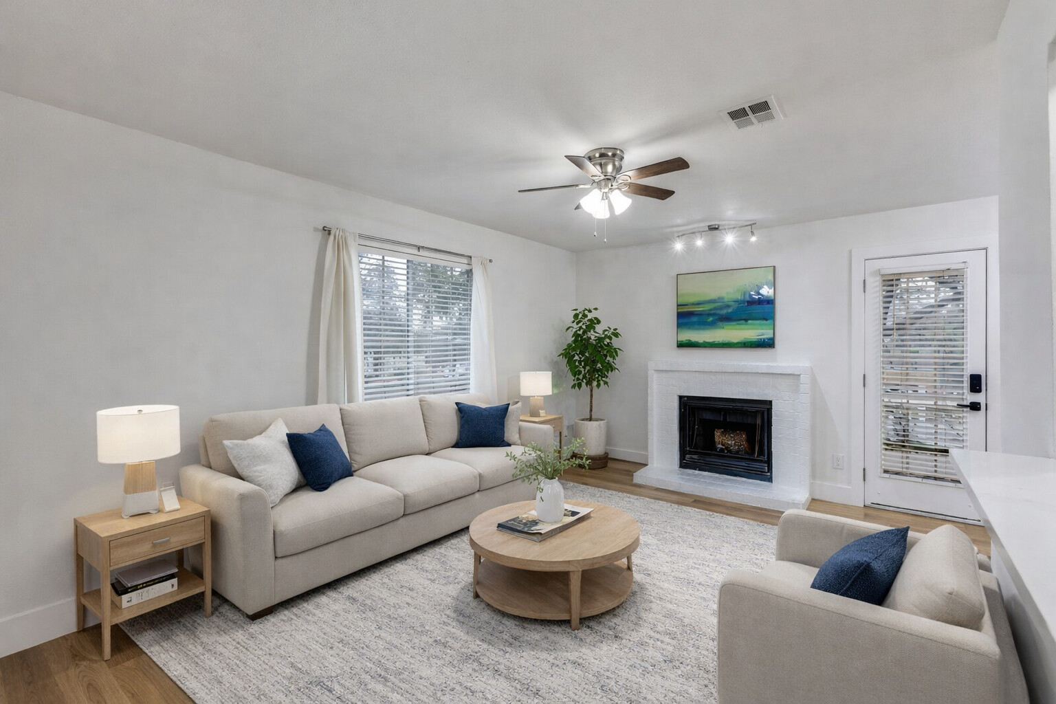 1845 River Crossing Circle, Unit A Austin, TX 78741 - Photo 10 of 31 Living area with a fireplace, wood finished floors, and ceiling fan