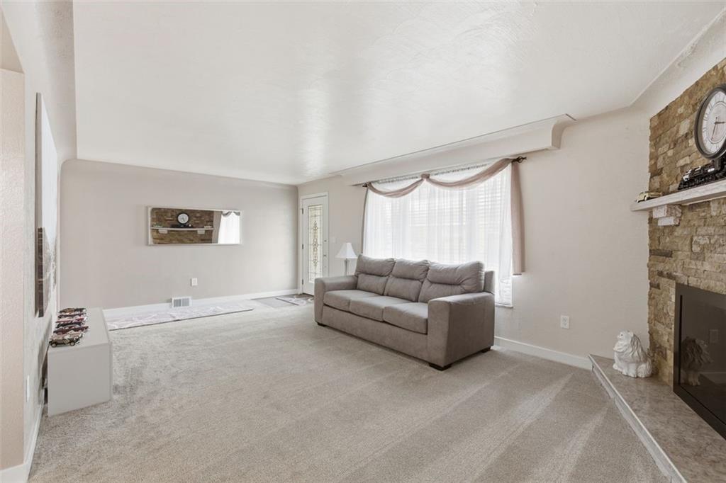 120 Crestview Manor Monongahela, PA 15063 - Photo 10 of 38 a living room with furniture a fireplace and a large window