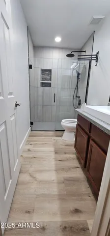 an entryway with wooden floor and a hallway