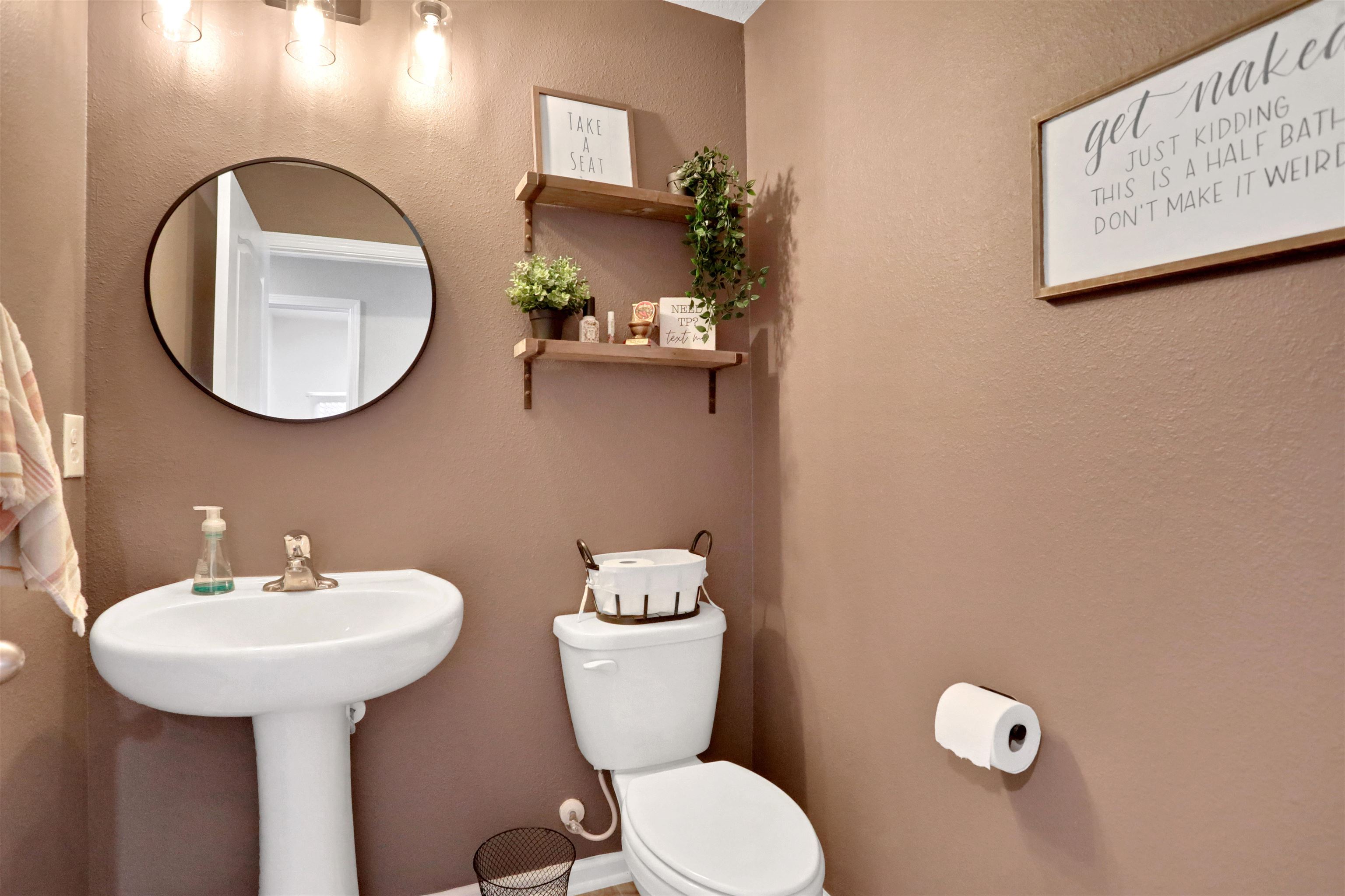 123 Hickory Ridge Road St. Augustine, FL 32084 - Photo 18 of 29 a bathroom with a toilet sink and mirror