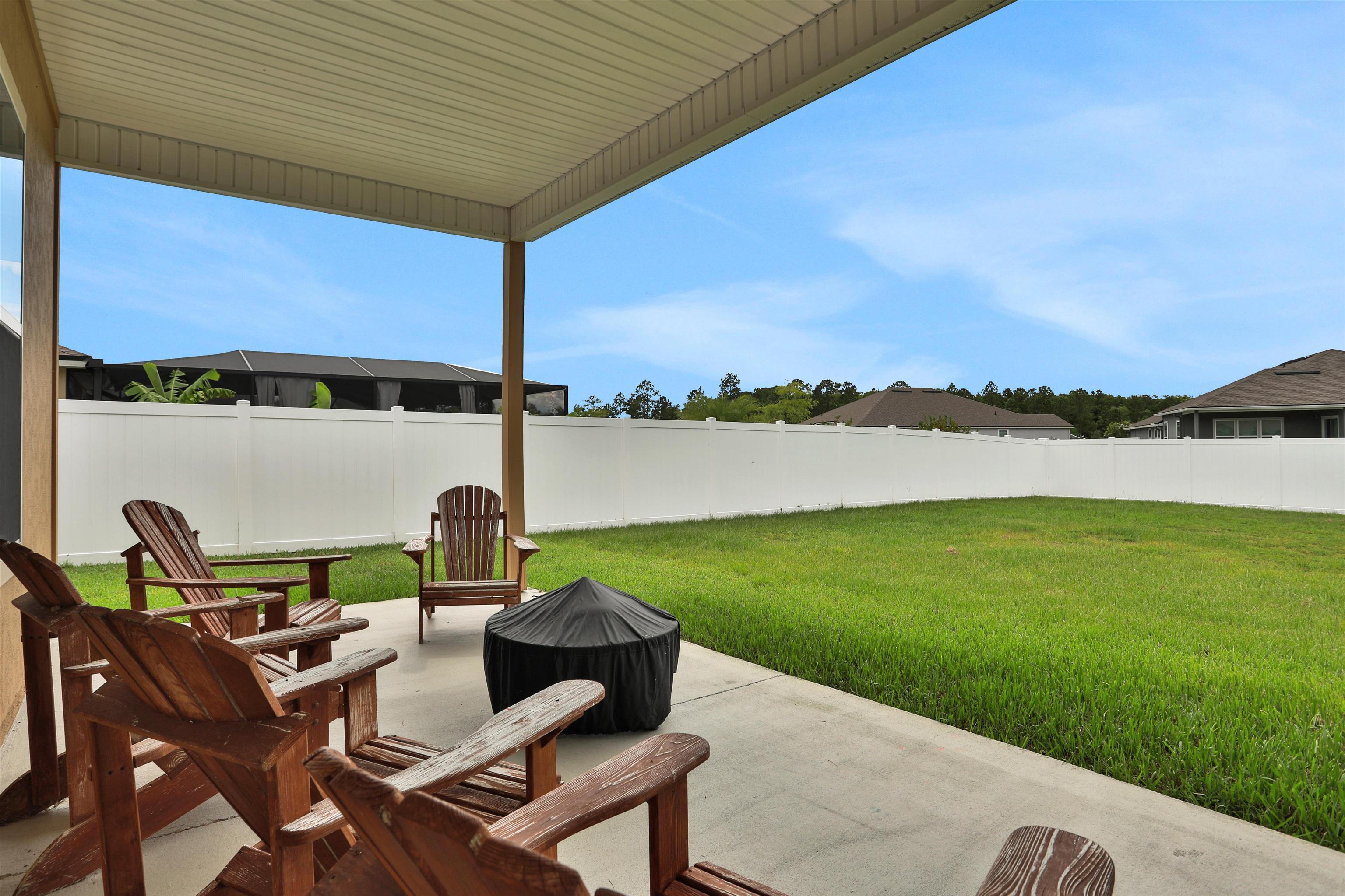 123 Hickory Ridge Road St. Augustine, FL 32084 - Photo 26 of 29 a view of a patio with lawn chairs and a table