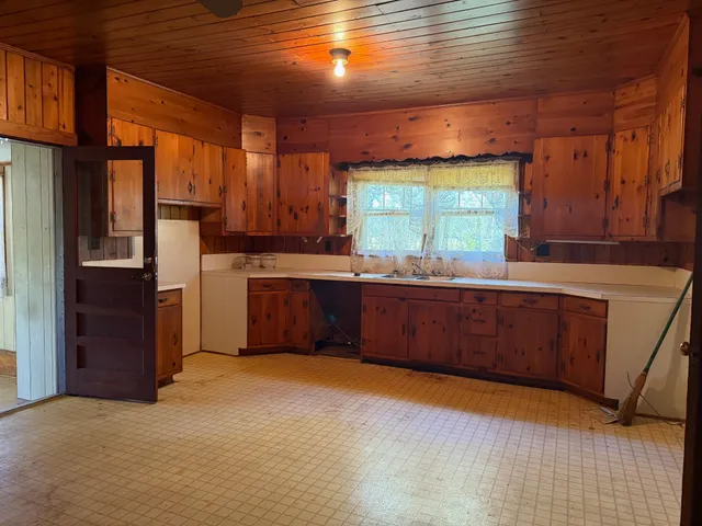 a kitchen with stainless steel appliances granite countertop a sink counter space and a window