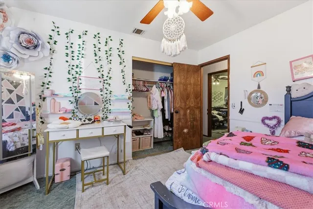 a bathroom with a granite countertop sink mirror vanity and toilet