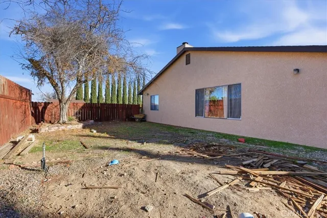 a view of a backyard with sitting area