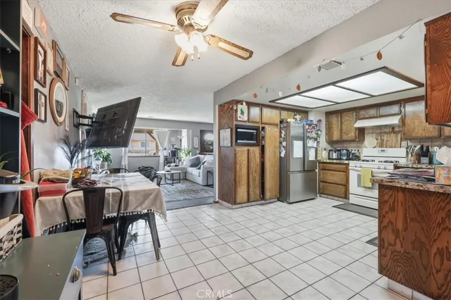 a kitchen with stainless steel appliances granite countertop a refrigerator and a stove top oven