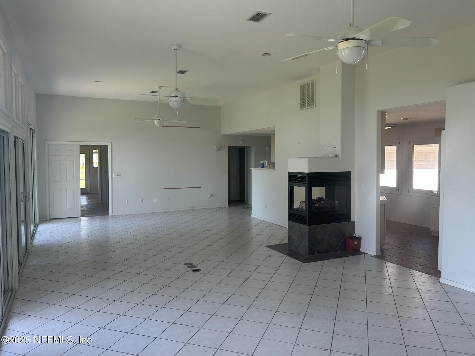 121 Walton Road East Palatka, FL 32131 - Photo 17 of 48 an empty room with fireplace and windows