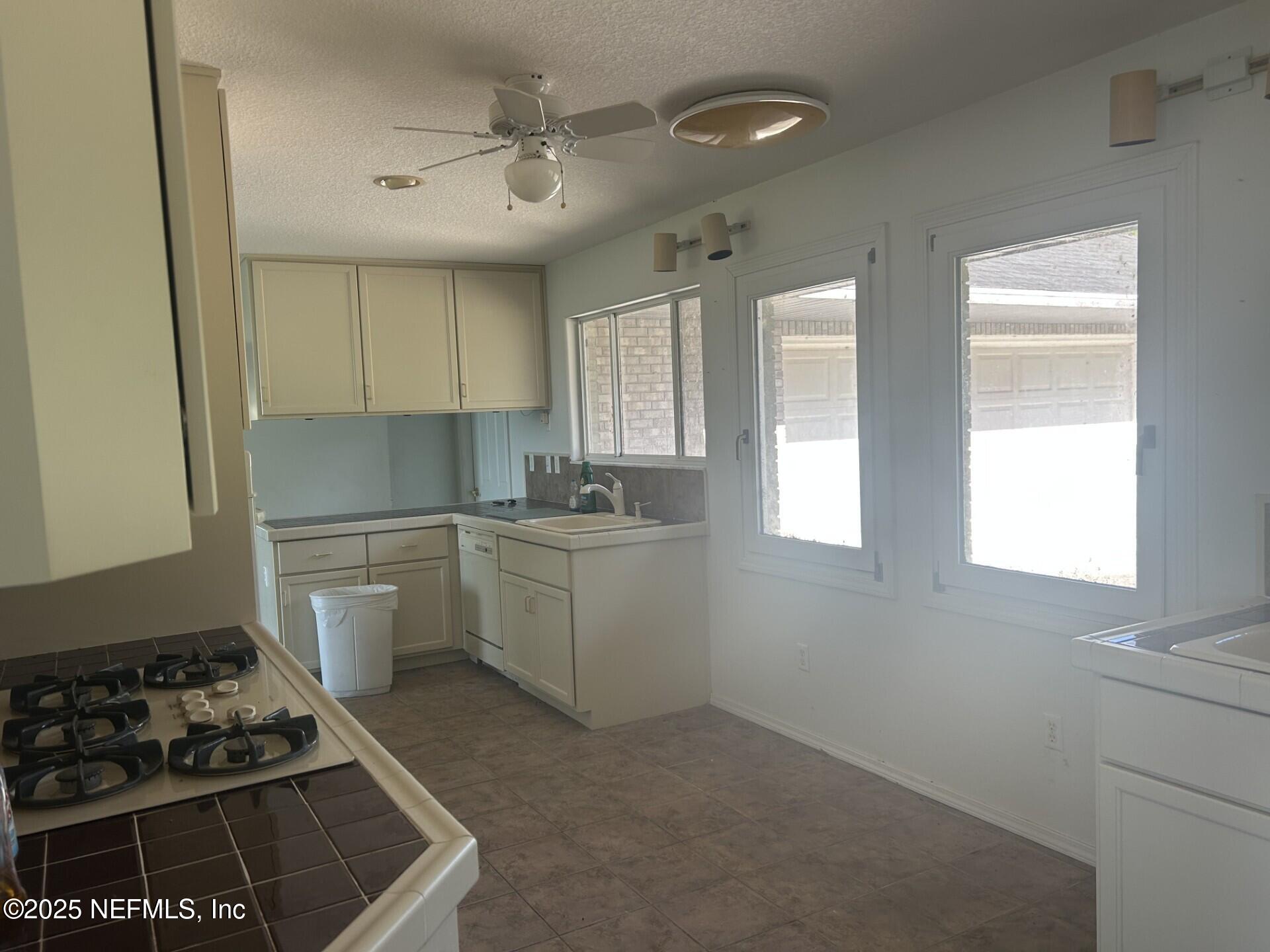 121 Walton Road East Palatka, FL 32131 - Photo 21 of 48 a kitchen with a stove a sink and a window