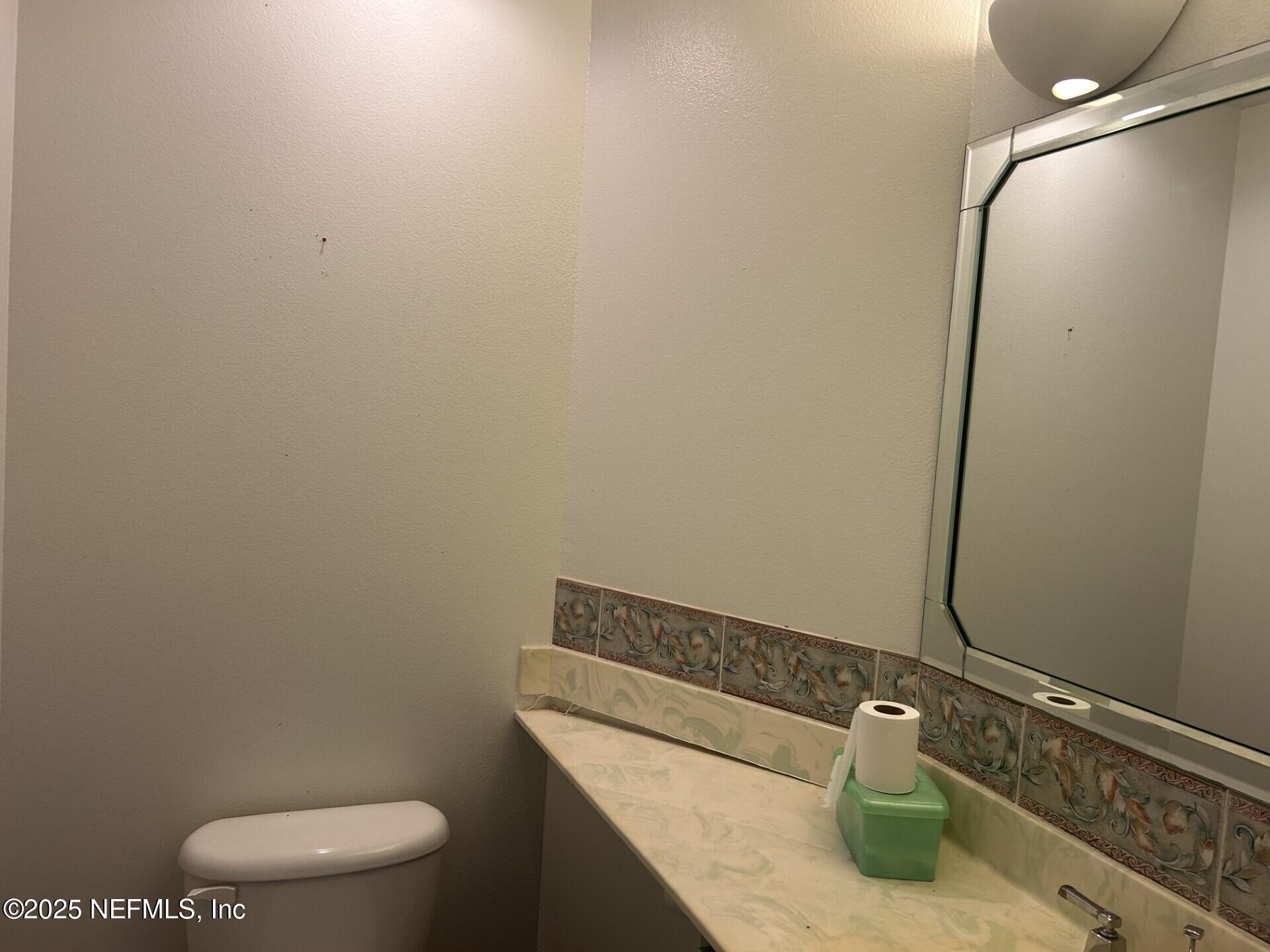 121 Walton Road East Palatka, FL 32131 - Photo 27 of 48 a bathroom with a granite countertop toilet and sink