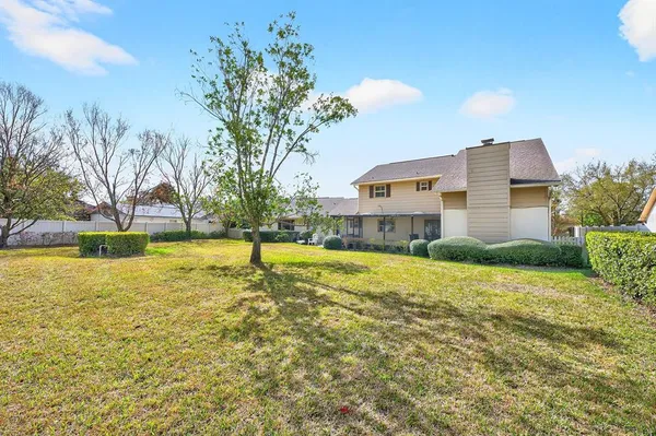 a house view with swimming pool in front of it
