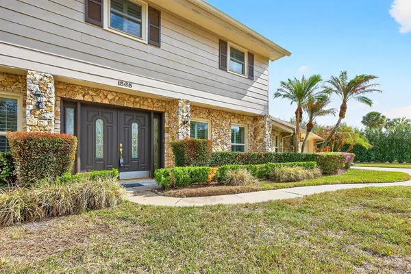 a front view of a house with a garden