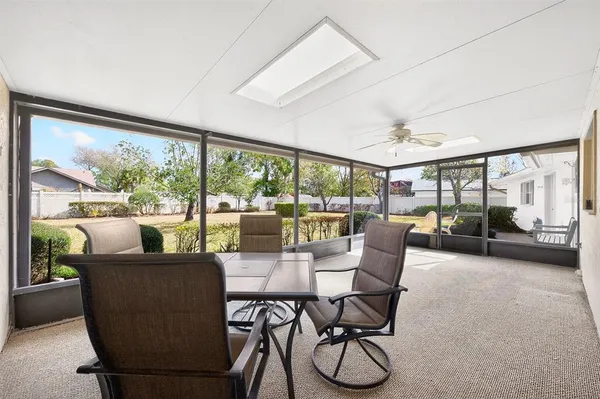 a view of a dining room with furniture large windows and wooden floor