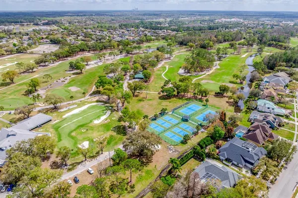 a view of an empty room with a window and chandelier