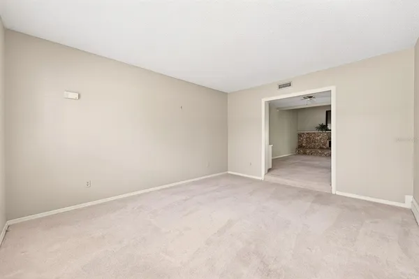 a view of a livingroom with a chandelier fan and a window