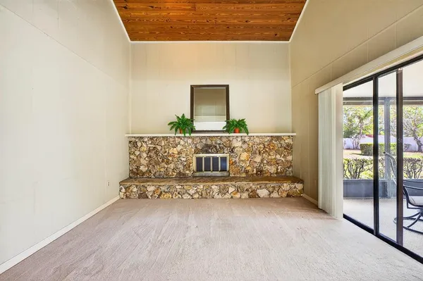 a living room with furniture and large windows