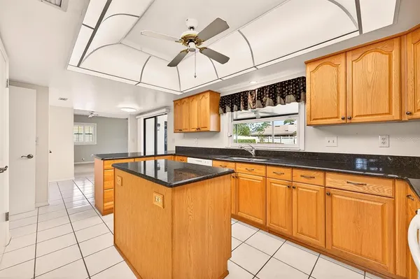 a kitchen with stainless steel appliances granite countertop a sink and cabinets