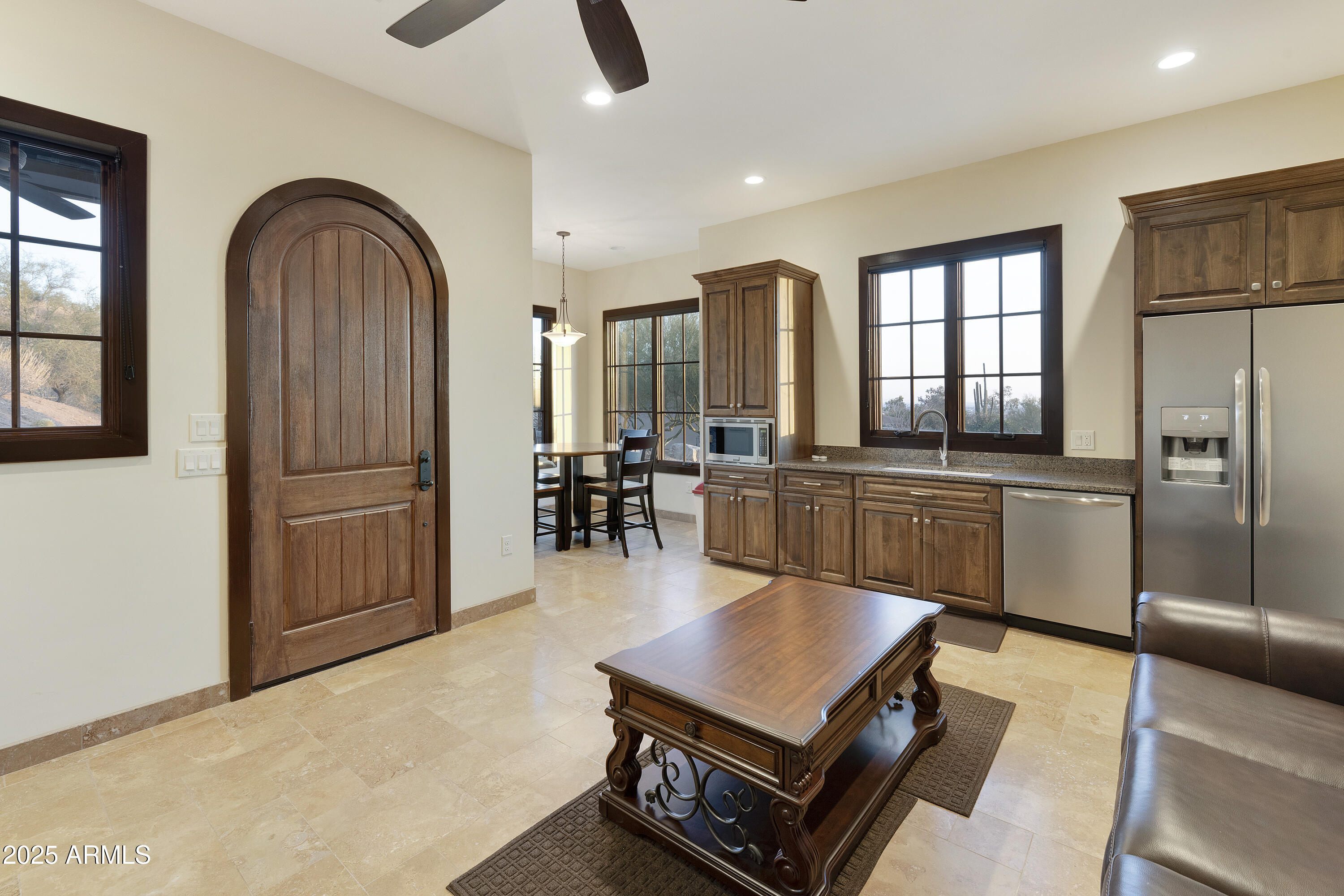 5117 North Cortez Road Apache Junction, AZ 85119 - Photo 39 of 61 a living room with furniture a kitchen island with stainless steel appliances wooden floor and cabinets