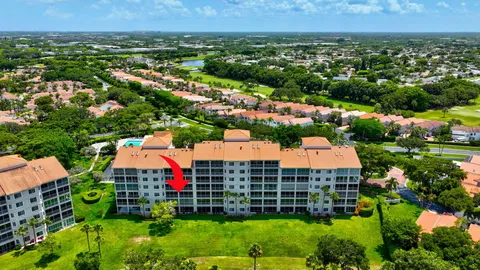 an aerial view of residential houses with outdoor space and swimming pool