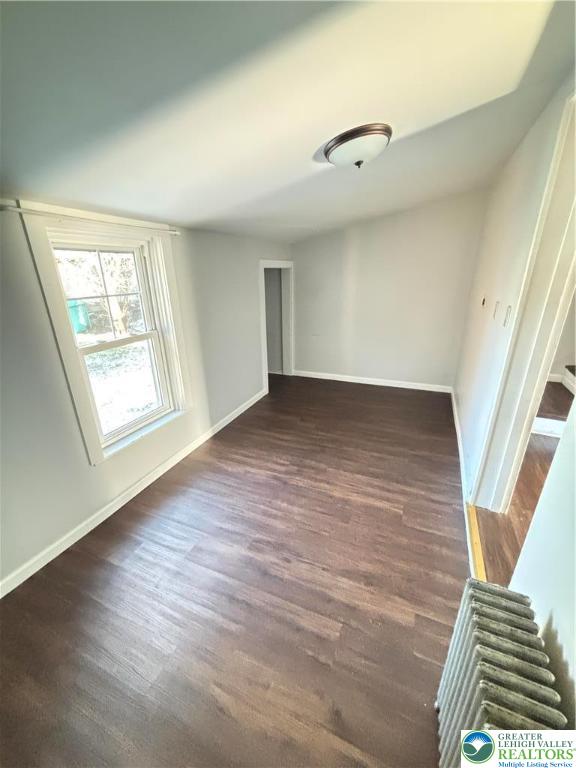 213 Penn Street Bath, PA 18014 - Photo 15 of 22 an empty room with wooden floor cabinet and windows