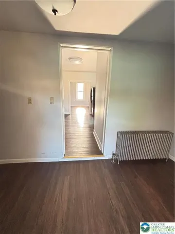 a view of a room with wooden floor