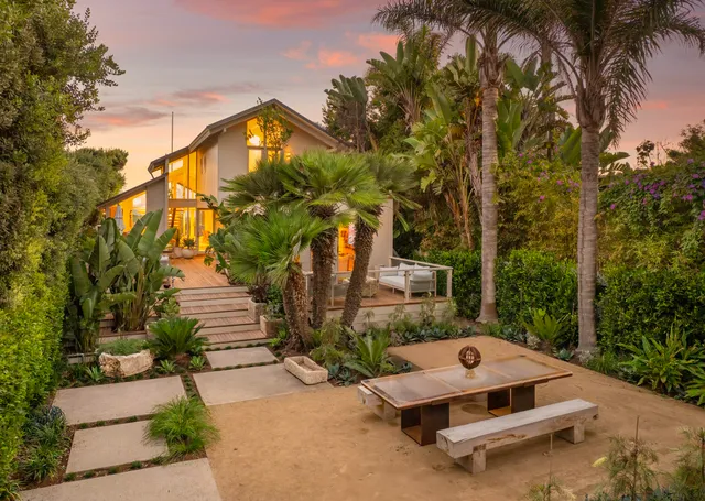 a wooden bench sitting in front of a house
