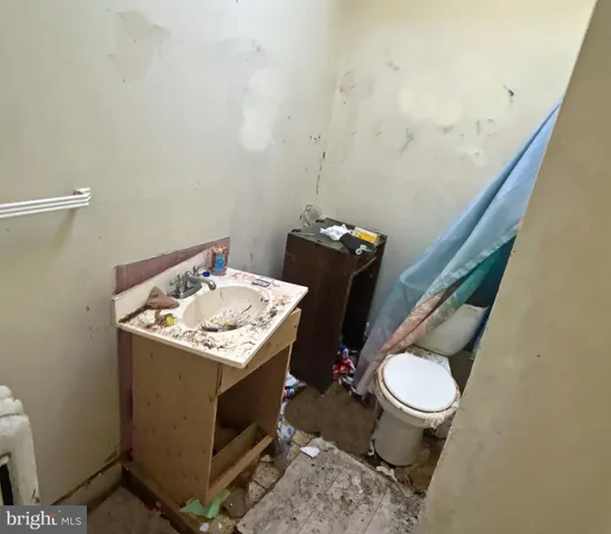 a bathroom with a sink toilet and mirror