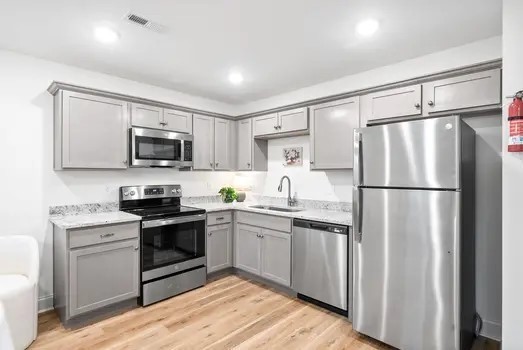 940 Britton Springs Road, Unit 605 Clarksville, TN 37042 - Photo 10 of 30 a kitchen with white cabinets stainless steel appliances and a refrigerator