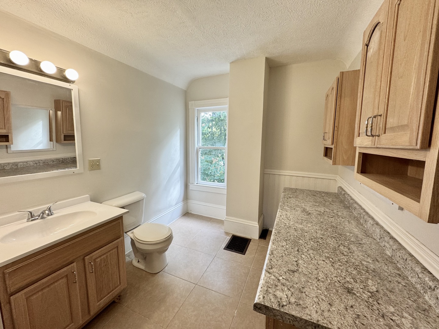 304 South Prairie Street Bloomington, IL 61701 - Photo 25 of 34 a bathroom with a sink a toilet and a mirror
