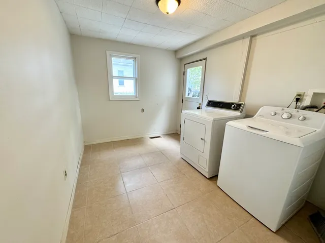 an empty room with windows and entrance