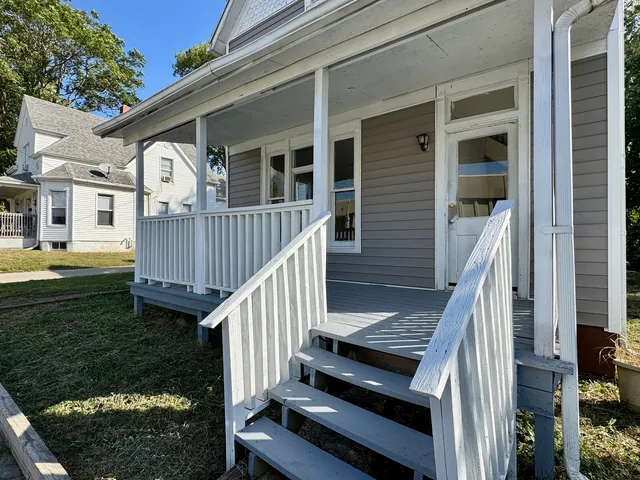 a view of a house with backyard and wooden deck