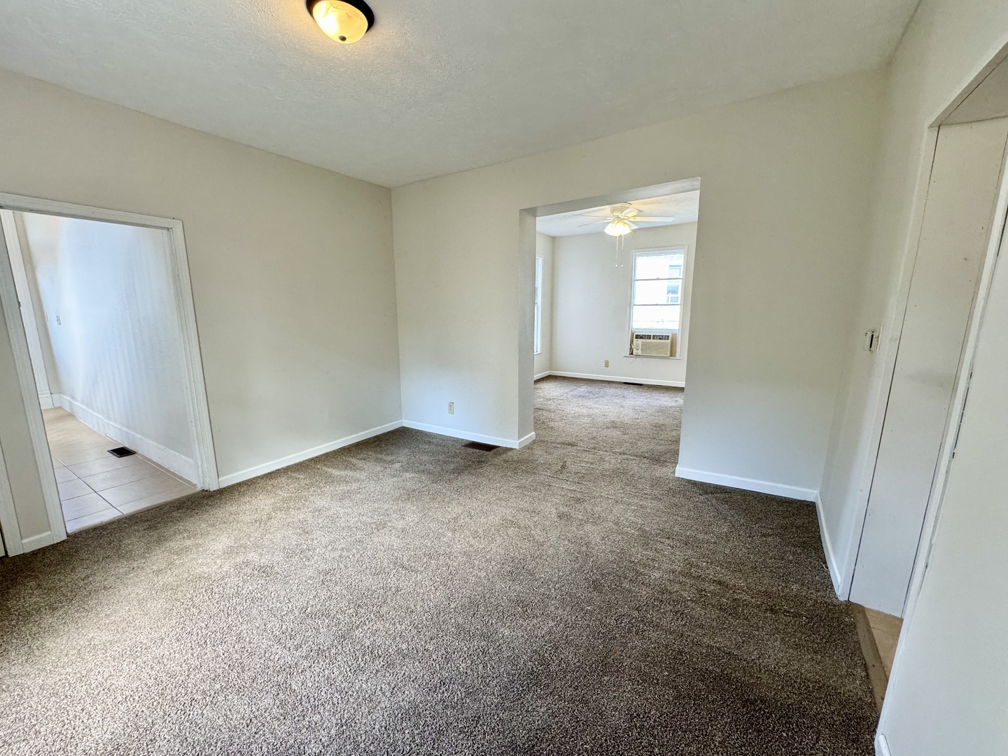 304 South Prairie Street Bloomington, IL 61701 - Photo 6 of 34 an empty room with windows and entrance