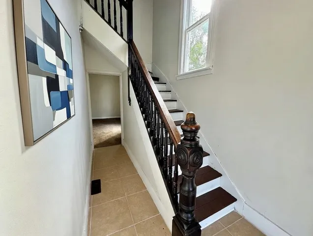 a bathroom with a tub sink shower and mirror